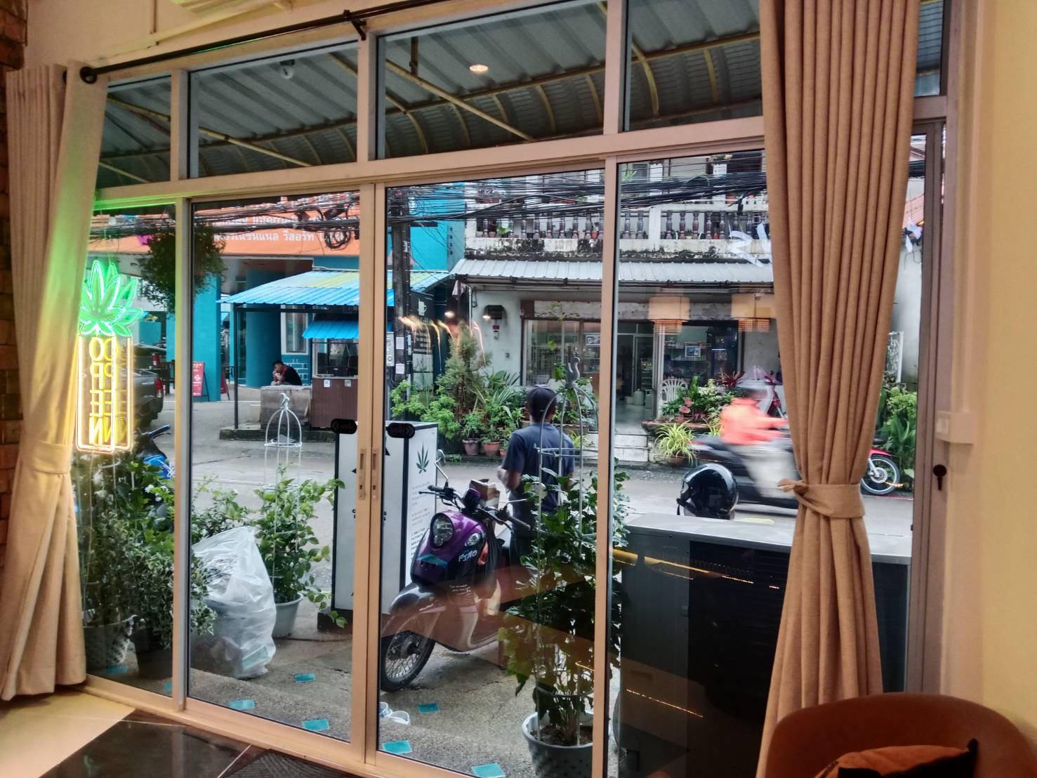 Heat and glare film on a street-facing café frontage in Patong, Phuket