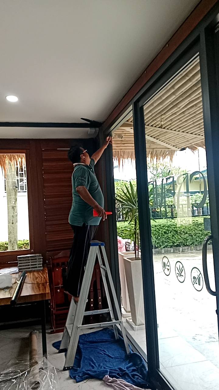 JaiDeeClear technician installing window film on a shopfront in Phuket
